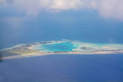 Aerial view of Rangiora atoll showing the lagoon's turquoise waters and the white sand beaches 